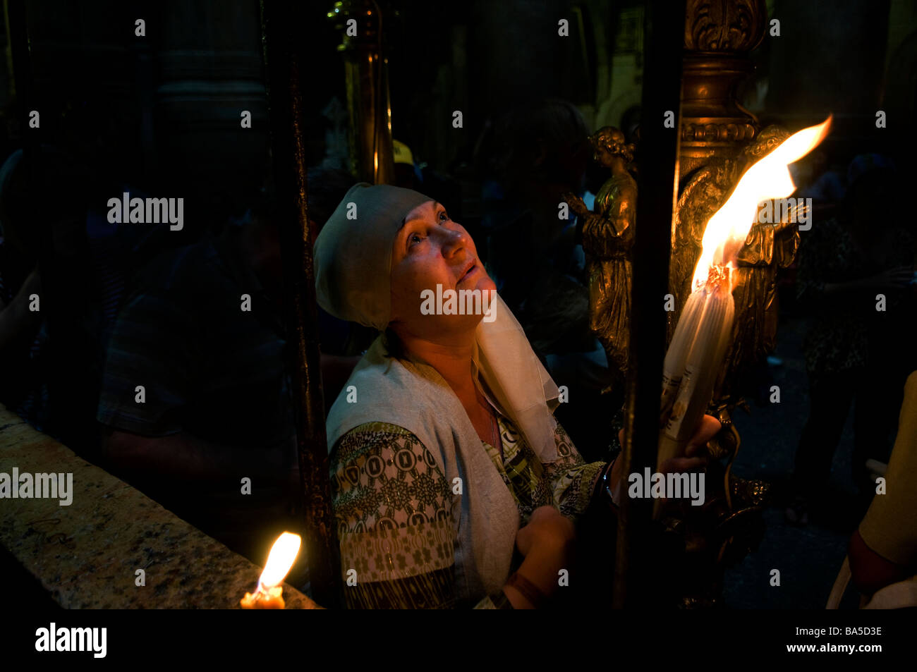 Un cristiano devoto tenere a lume di candela nella chiesa del Santo Sepolcro durante la processione del Venerdì Santo a Gerusalemme Israele Foto Stock