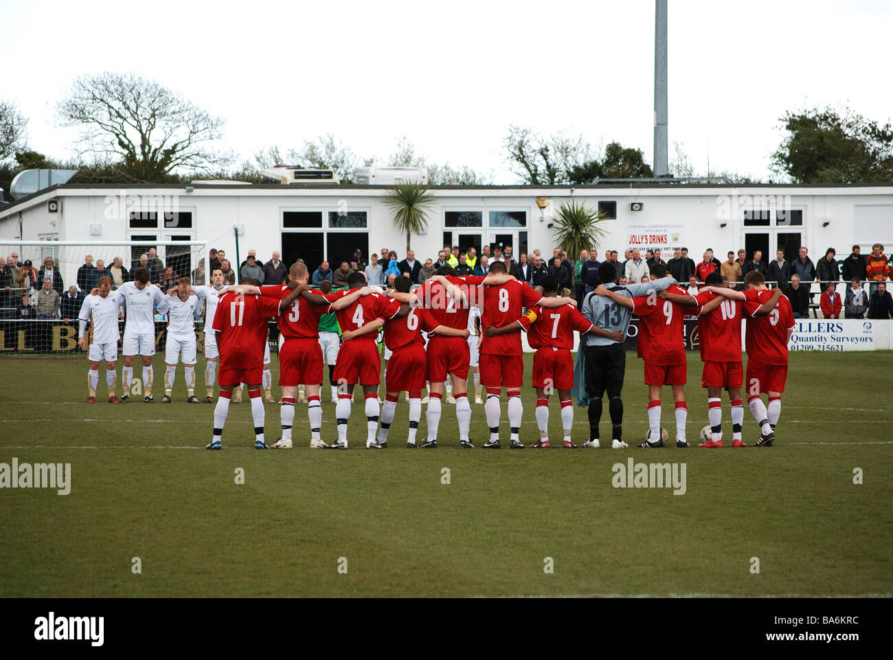 I giocatori di calcio osservando un minuto di silenzio prima di una partita tra truro city e afc hayes Foto Stock