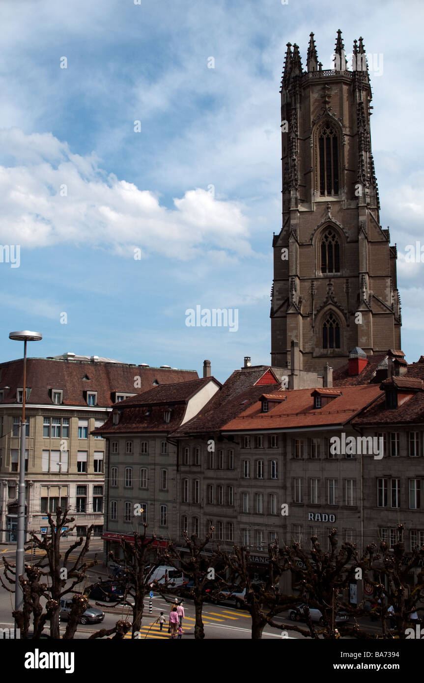 Tipici edifici su una strada commerciale supportato dalla torre gotica della Cattedrale di San Nicola, Fribourg, Svizzera Foto Stock