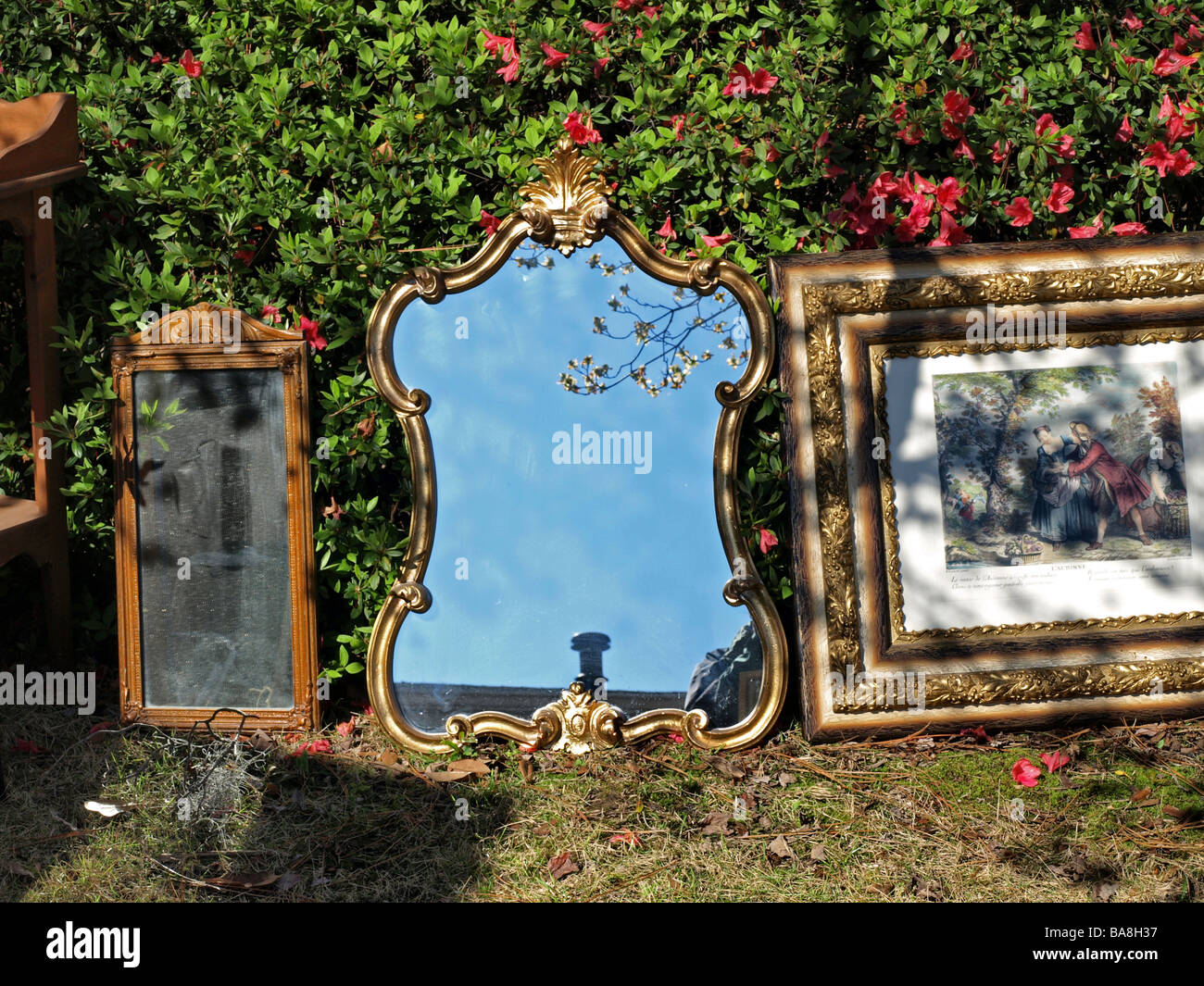 Due specchi e specchio con cornice oro opera d'arte foto seduta di fronte a una bussola sull'erba con le ombre e la luce diretta del sole vendita Foto Stock
