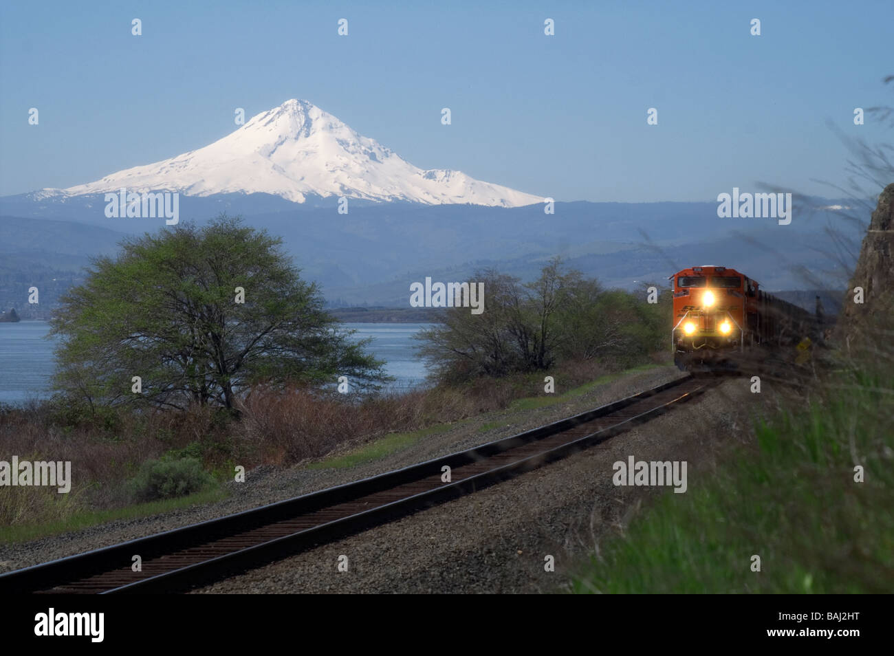 Un BNSF treno passa attraverso il Columbia River Basin con il monte Cofano incombente. Foto Stock