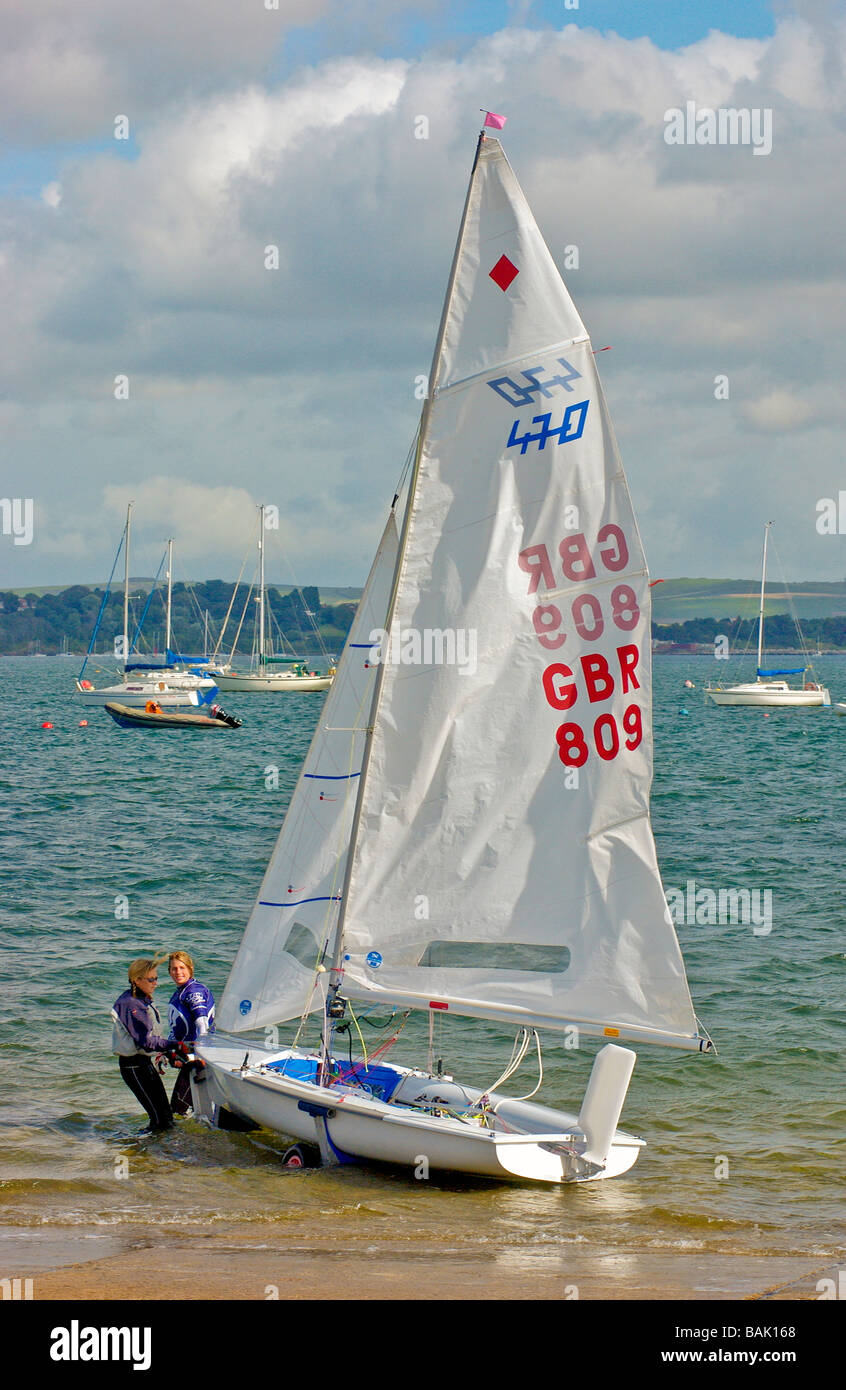 Il lancio di un internazionale e Olympic 470 class sailing dinghy a Weymouth e Portland Academy a vela nel Dorset England Regno Unito Foto Stock