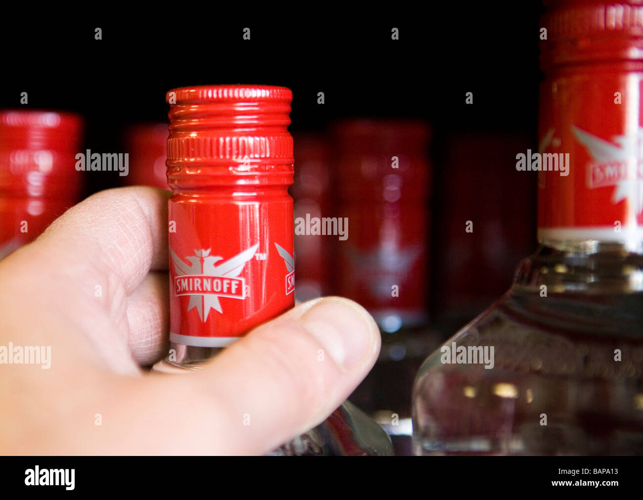 Bottiglie di Smirnoff vodka sul ripiano in una licenza off Foto Stock