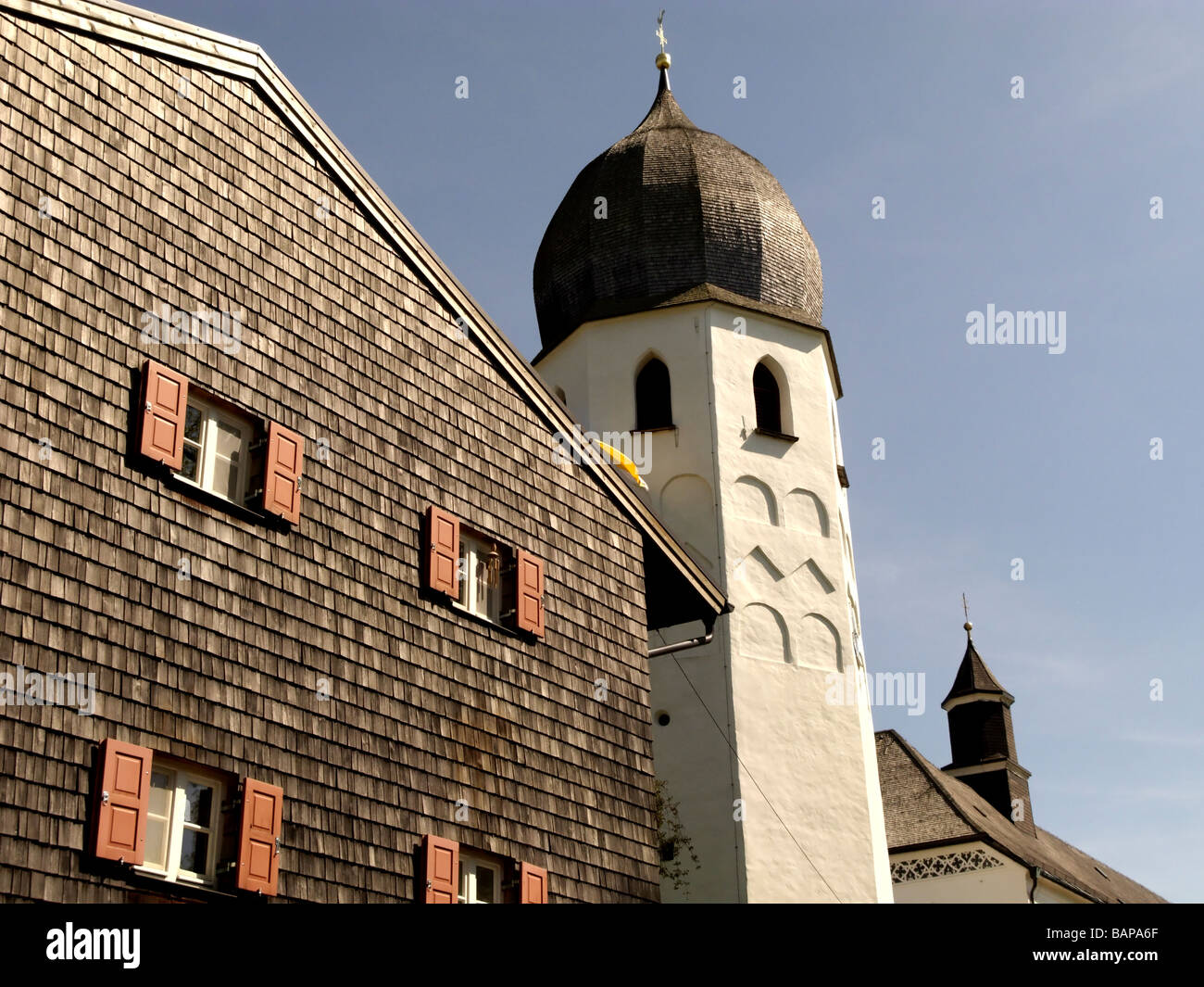 Parete di scandole chiesa edificio torre con orologio, campanile, il monastero benedettino di Frauenwoerth, isola di Fraueninsel, Foto Stock