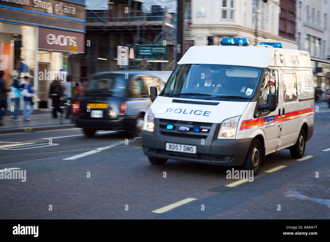 La polizia van con luci blu lampeggiante di rispondere all emergenza in Oxford Street a Londra, Inghilterra Foto Stock