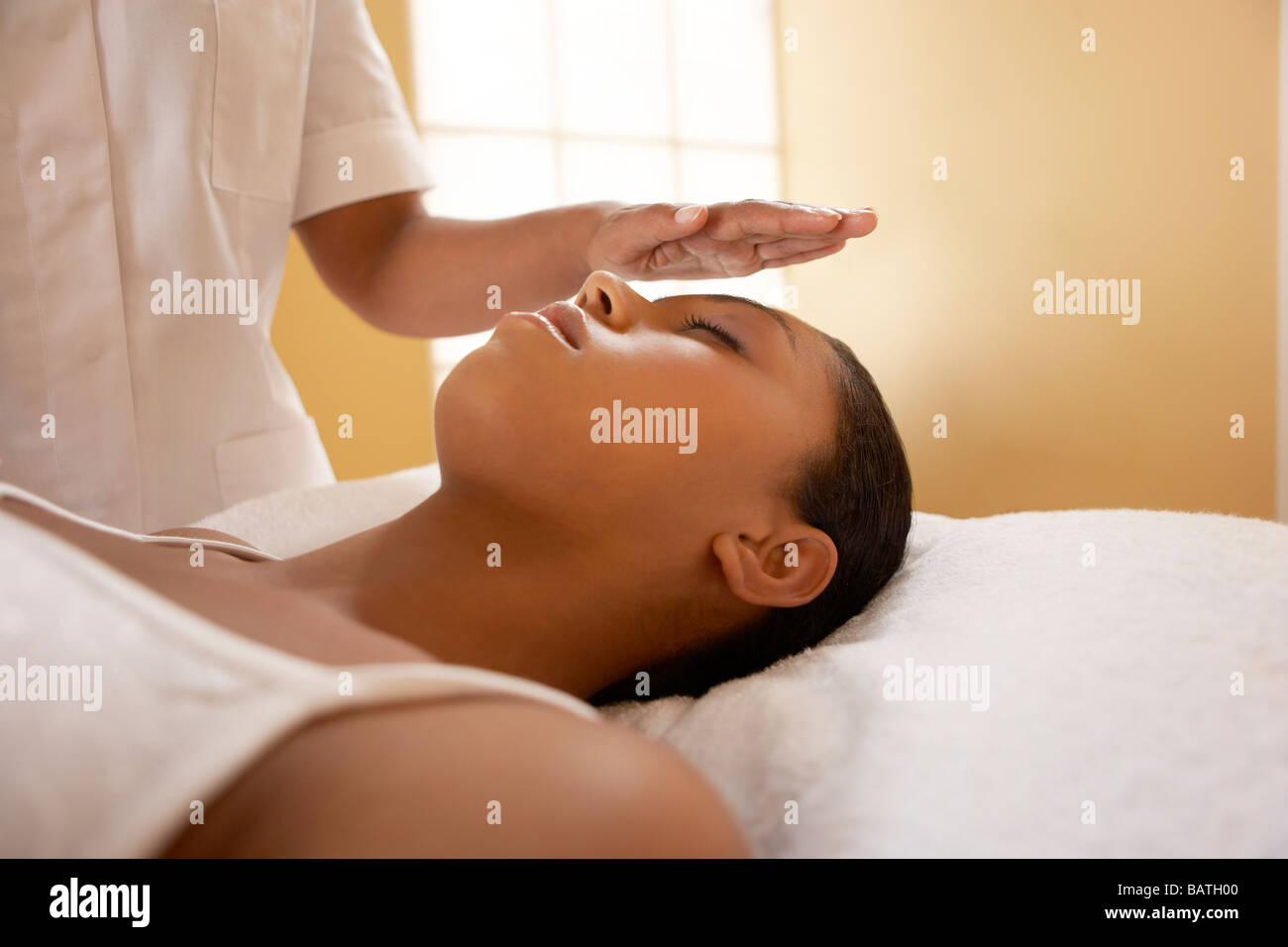 La guarigione spirituale.guaritore spirituale il trattamento di un client. Lei sta usando le mani al canale una energia di guarigione dal suo corpo. Foto Stock