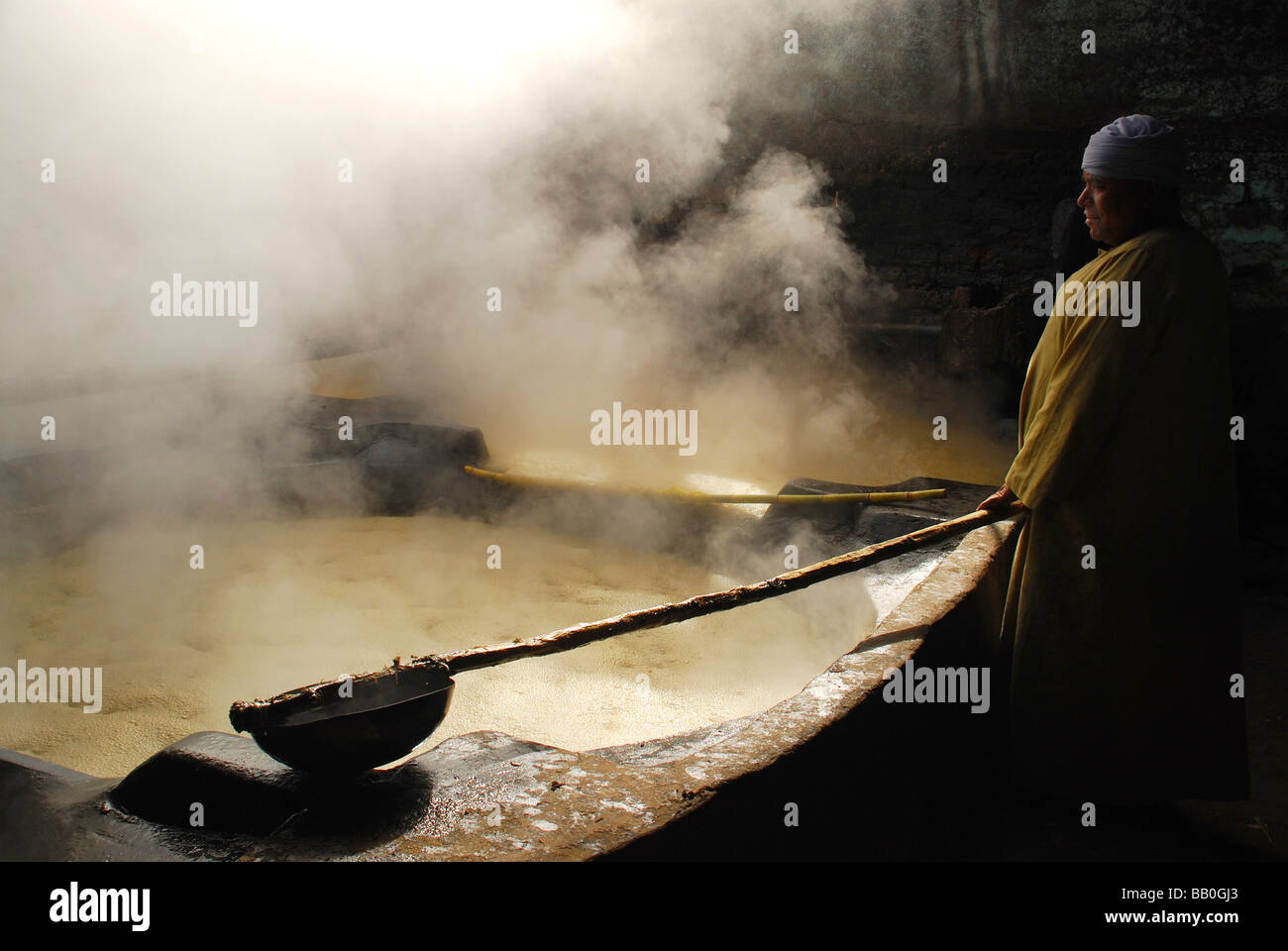 Lavoratore egiziano in una melassa o "nero miele" paese fabbrica in Egitto Foto Stock
