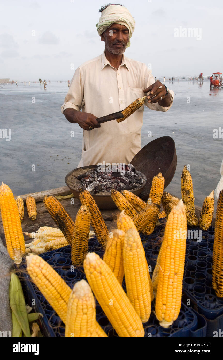 Vendere il mais sulla spiaggia di Clifton e Karachi in Pakistan Foto Stock