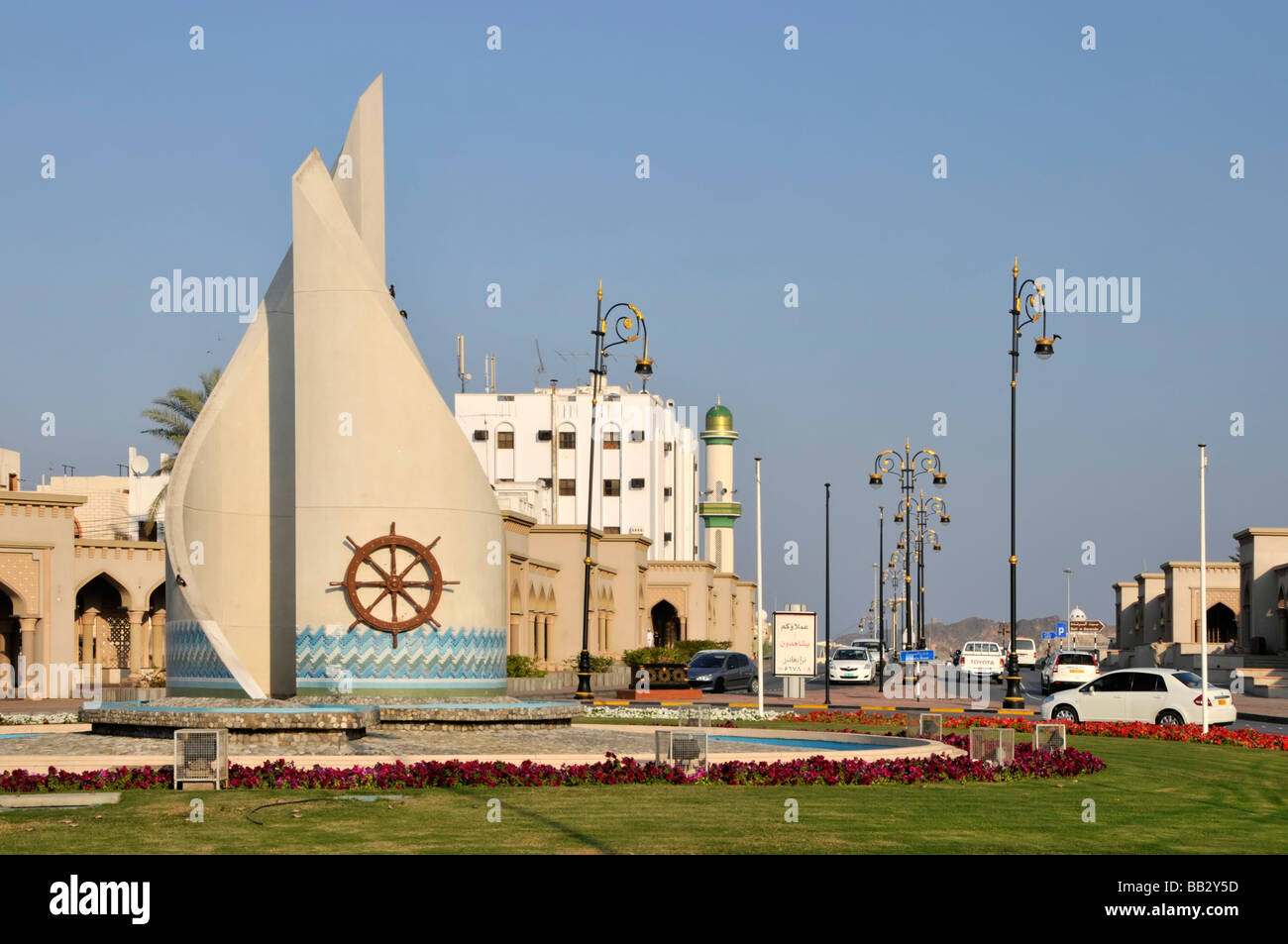 Strade e rotonda vicino l'ingresso al porto Sultan Qaboos Muttrah Muscat Oman con uffici porta al di là di Foto Stock