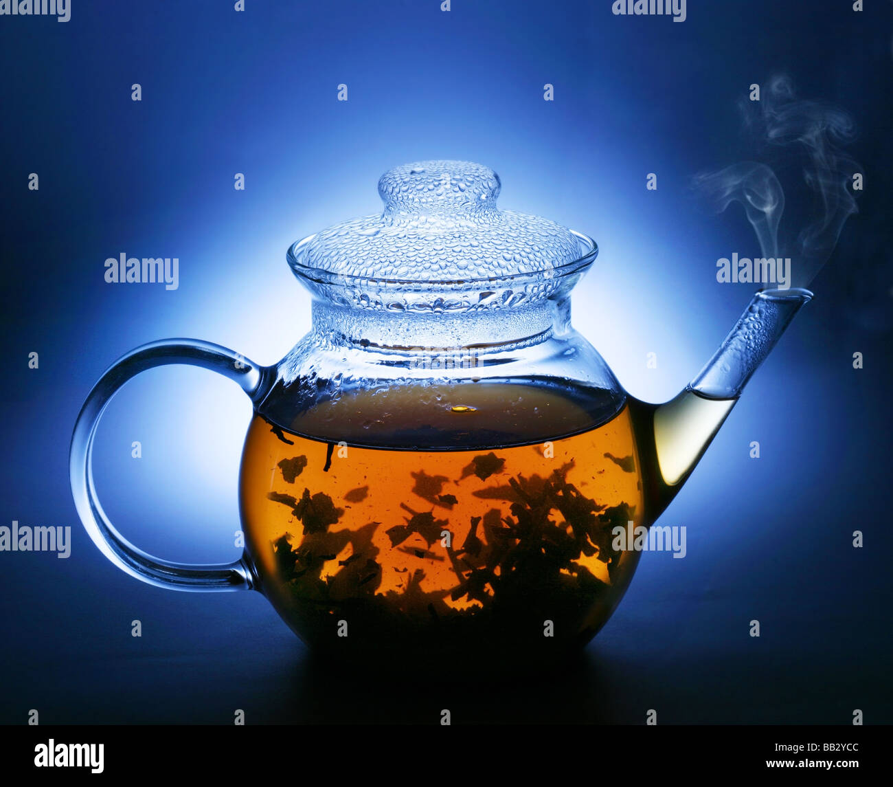 Teiera con il tè su uno sfondo blu scuro Foto Stock