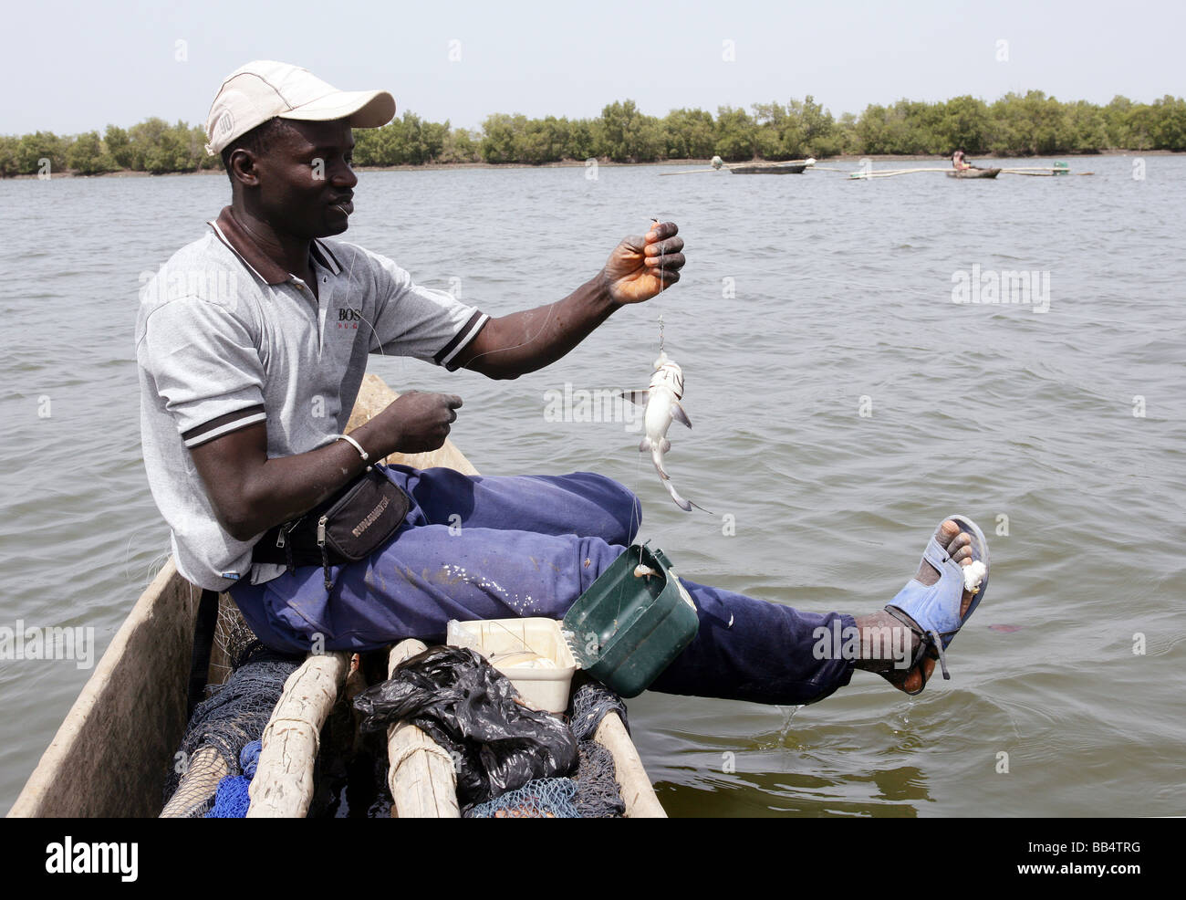Senegal: pescatore nella sua piroga sul fiume Casamance Foto Stock