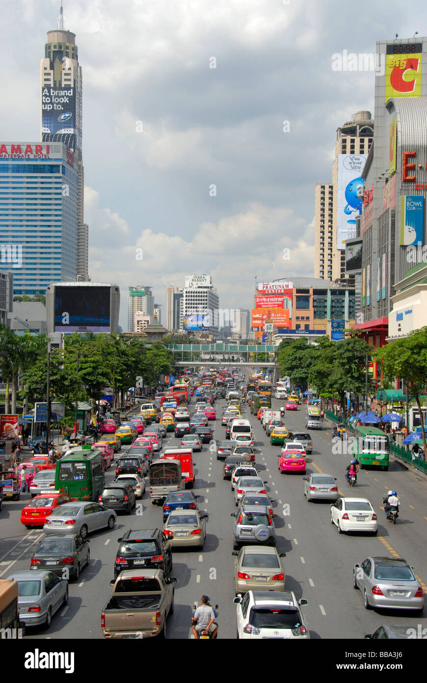 Grande città, ingorghi di traffico, auto e ciclomotori, nella parte anteriore del coloratissimo skyline, Ratchadamri Road, Bangkok, Thailandia, Sud-est asiatico Foto Stock