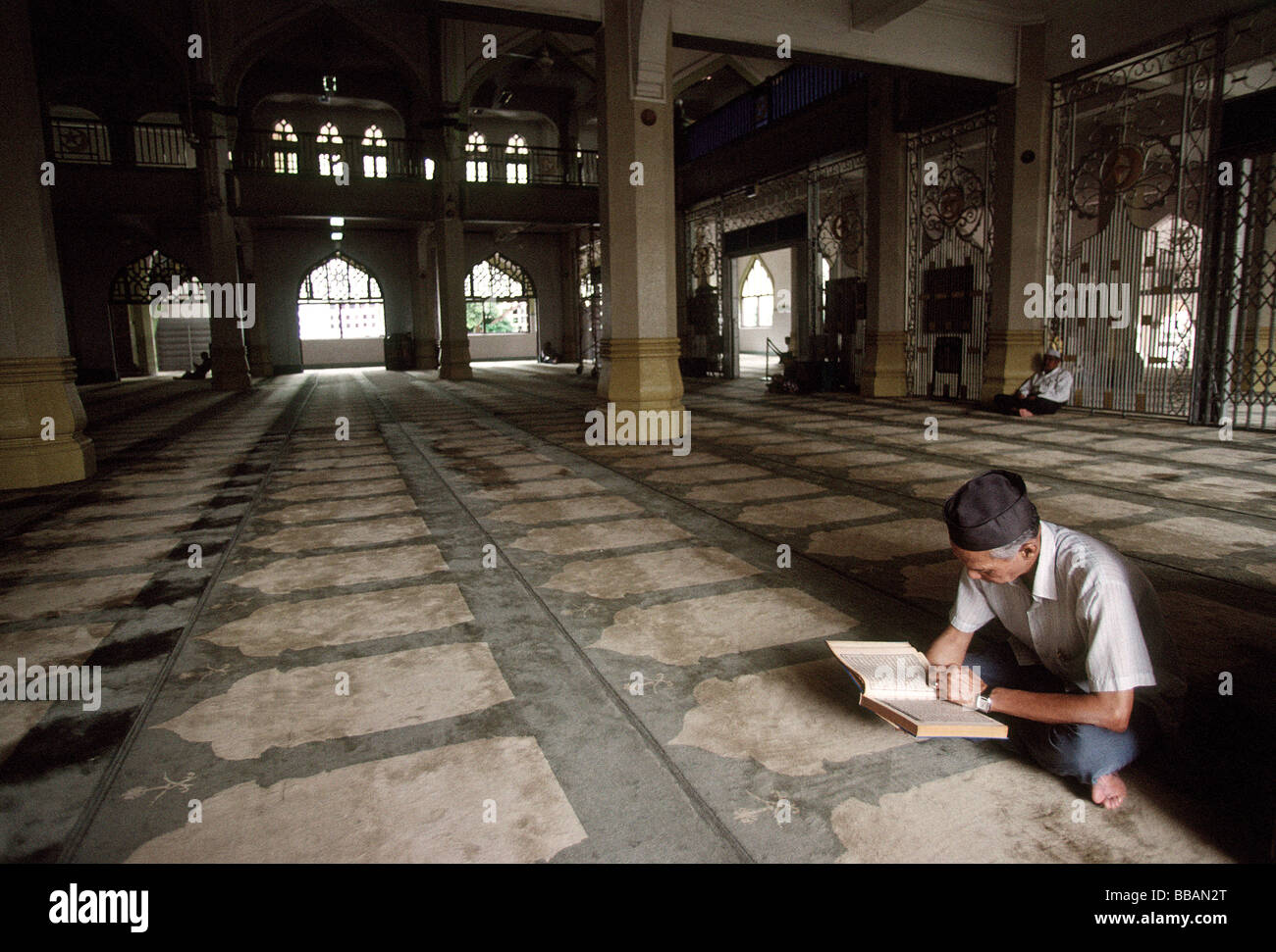 Singapore, Strada araba e musulmana uomo legge Corano nella moschea. Foto Stock