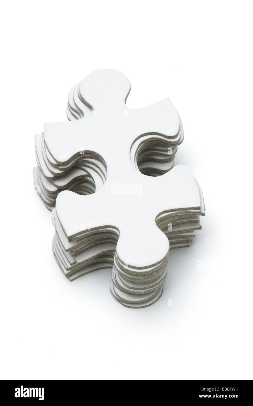 Pila di Jigsaw Puzzle pezzi su sfondo bianco Foto Stock