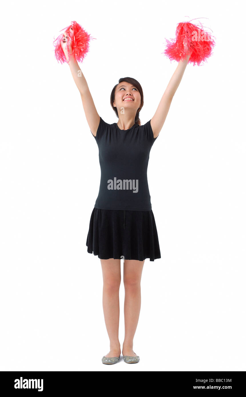 Giovane donna cheerleading con il pom pom Foto Stock