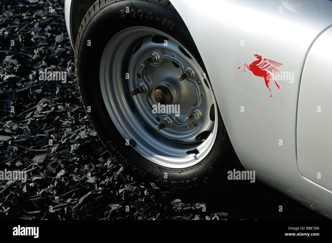 Primo piano della ruota anteriore e del parafango anteriore di una Porsche 718 RS Spyder, con anche l'adesivo rosso Pegasus. Fondo stradale nero. Foto Stock