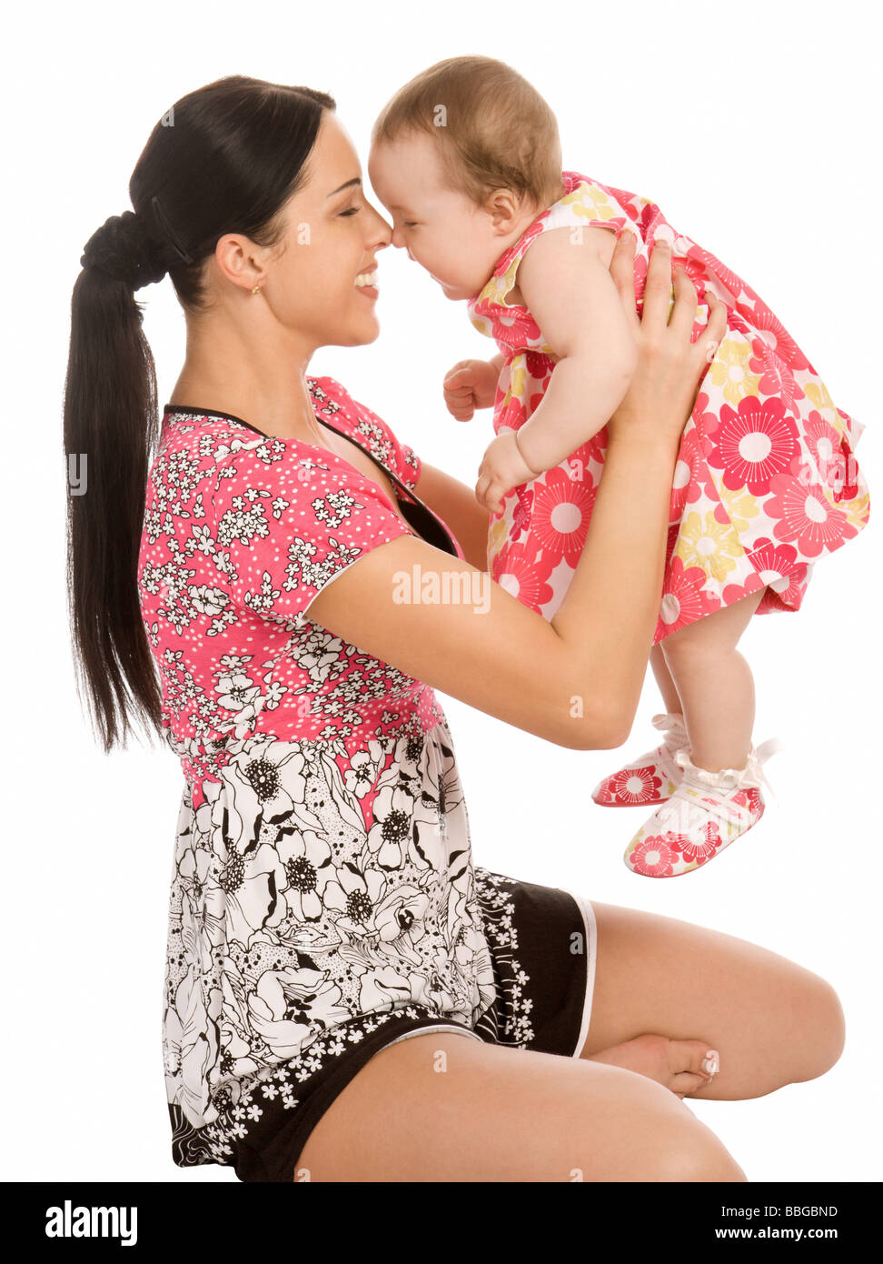 Giovane madre di tenere il suo neonato isolato su bianco Foto Stock