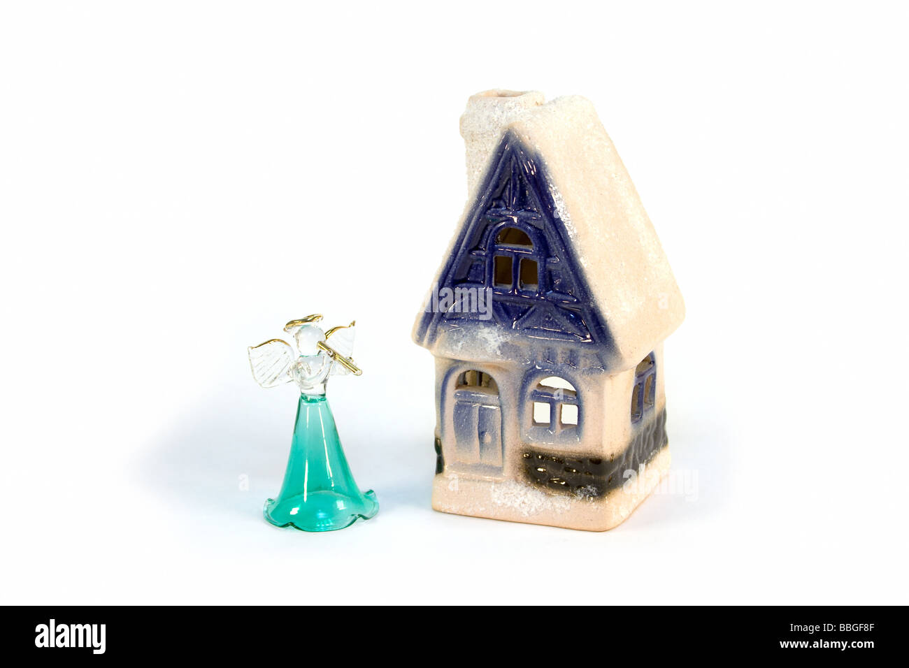 Il vetro angelo supporto vicino alla casa di ceramica Foto Stock