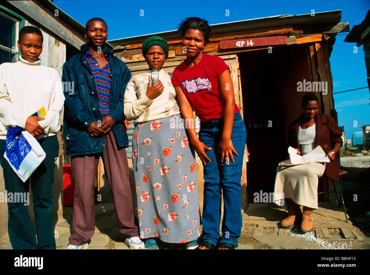 I residenti di Silahliwe pongono per la fotocamera al di fuori di uno dei loro baracche Ukuthasa ha lavorato sodo per ottenere questa terra ad essi assegnate Foto Stock