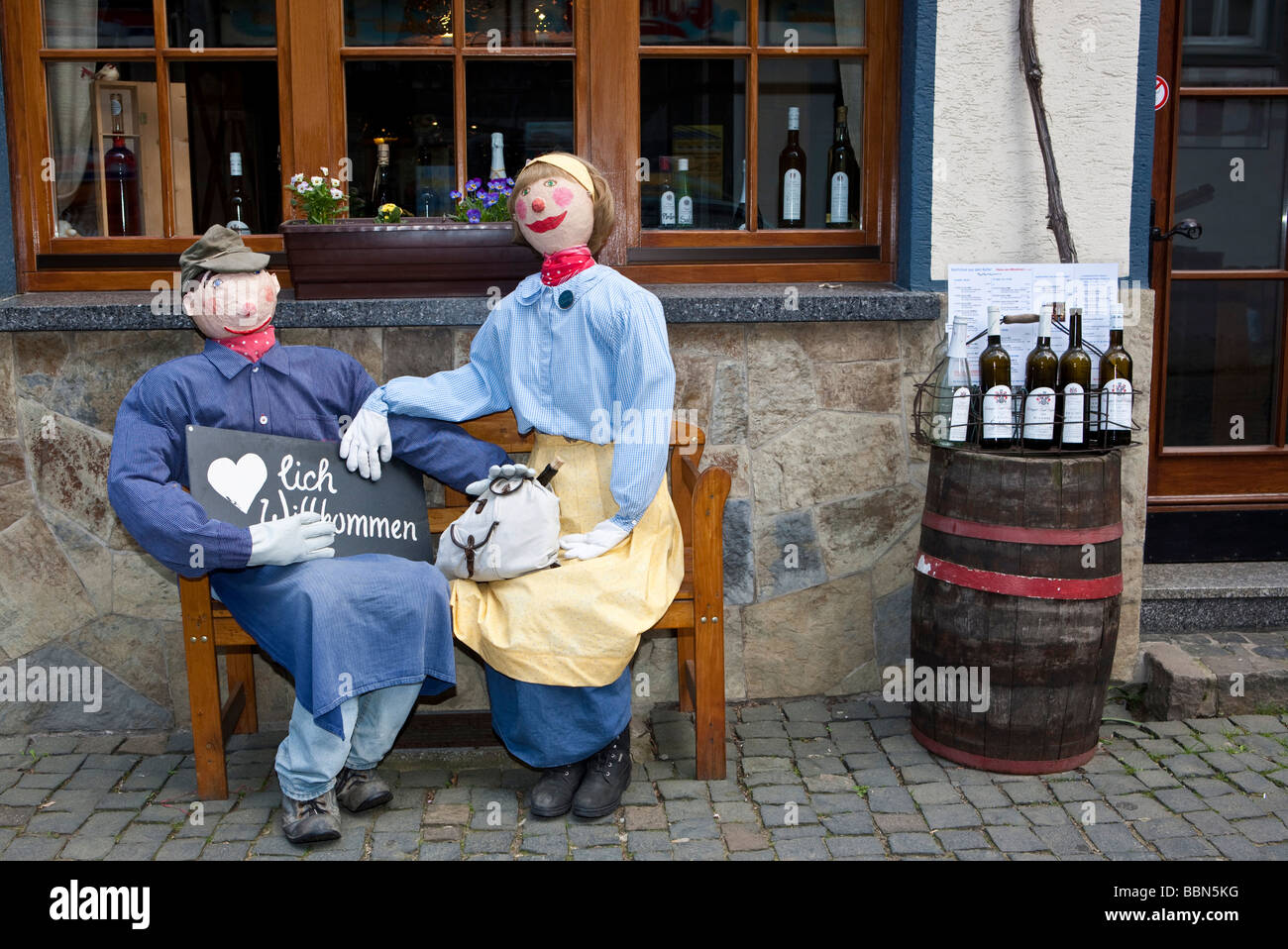 Le figure di fronte a un negozio di vino nella città vecchia di Bacharch, patrimonio mondiale Unesco Valle del Reno superiore e centrale, Bacharach Rhinel Foto Stock