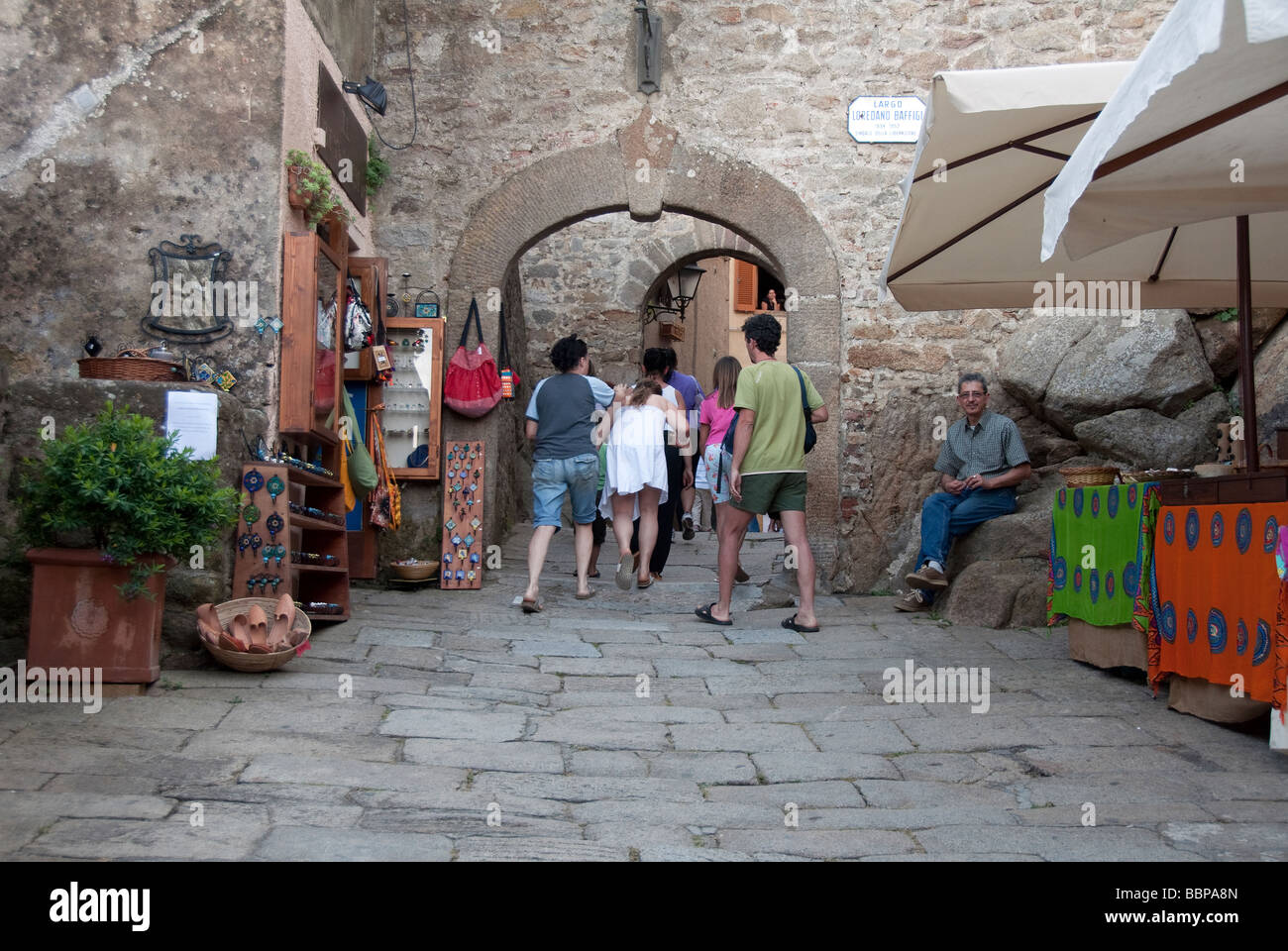 I turisti immettere il vecchio portale della città principale, Giglio Castello sull'isola del Giglio Foto Stock