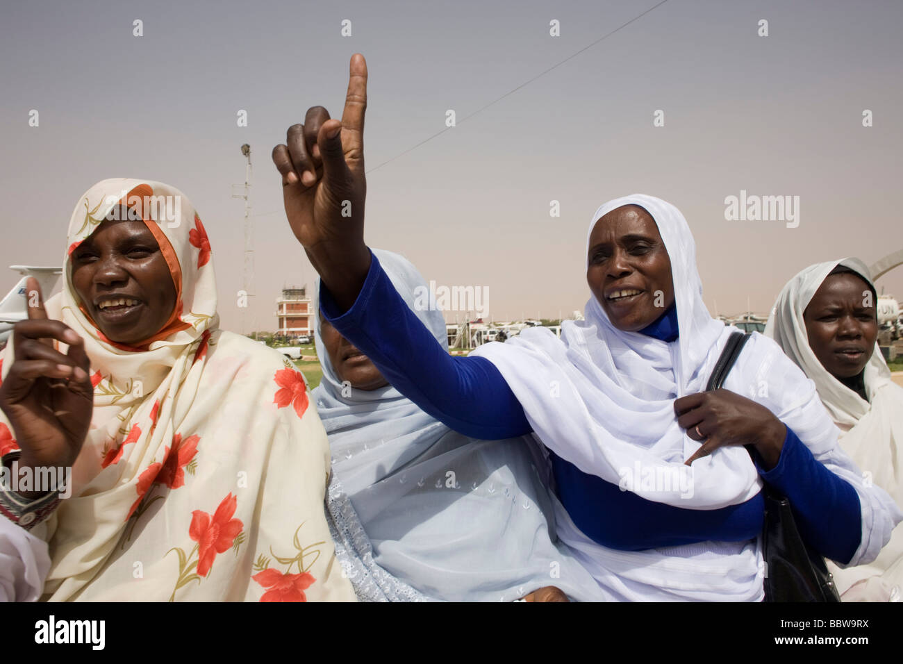 Donne Darfurian line-up su asfalto di Al Fashir aeroporto Sudan per salutare delegazione di peer britannico Lord Ahmed Foto Stock