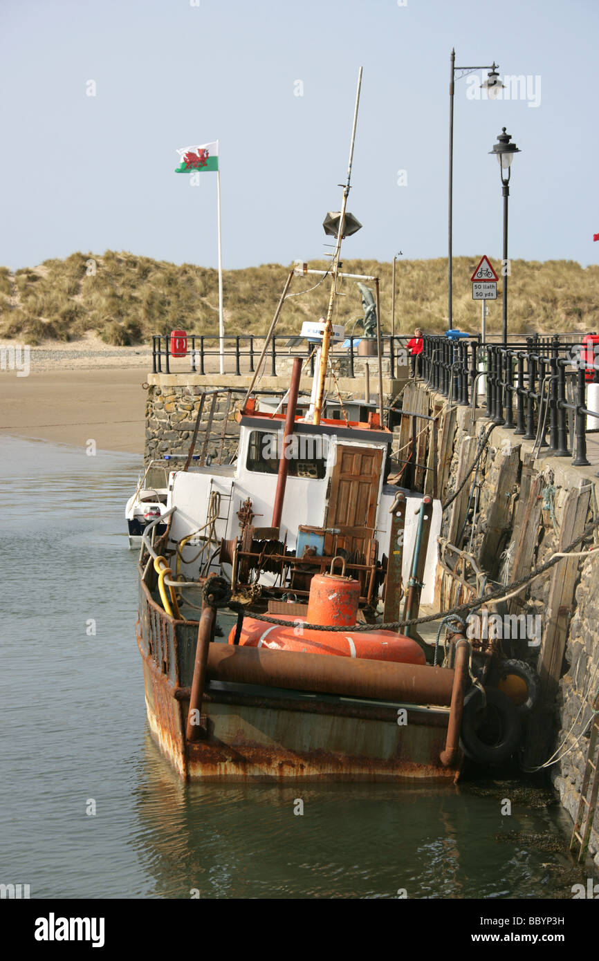 Città di Barmouth, Galles. Peschereccio legato al fianco di Barmouth Quay a bassa marea. Foto Stock