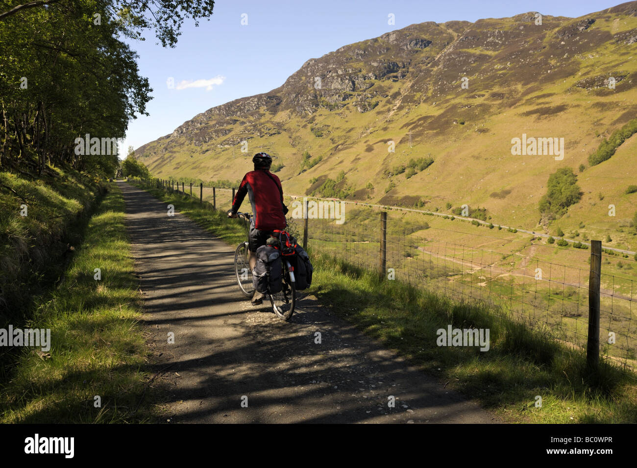 Ciclista sul ciclismo SUSTRANS route 7, un ex linea ferroviaria, al Glen Ogle, Scozia Foto Stock