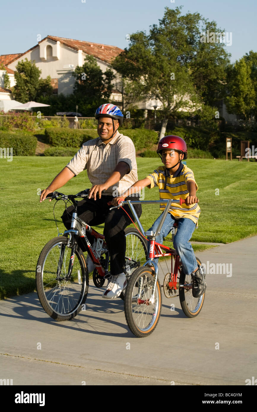 Bambini Padre bambino 8-9 anni di equitazione biciclette biciclette bike bicicletta assieme al di fuori della California etnica etnica genitore Stati Uniti © Myrleen Pearson Foto Stock