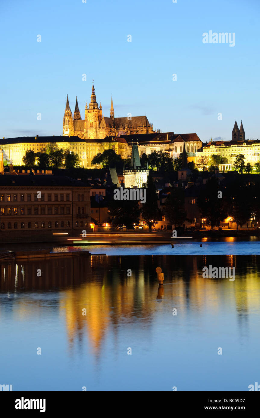 Castello di Praga e cattedrale di San Vito sul fiume Moldava Praga Repubblica Ceca // PRAGA, Repubblica Ceca - il complesso illuminato del castello di Praga, che presenta le guglie gotiche della cattedrale metropolitana dei Santi Vito, Venceslao e Adalberto, si riflette sul fiume Moldava al crepuscolo. Fondato nel IX secolo, il castello fu la sede storica del potere dei re boemi e degli imperatori del Sacro Romano Impero. La costruzione della cattedrale iniziò nel 1344 e non fu formalmente completata fino al 1929. Oggi il complesso funge da ufficio ufficiale del Presidente della Repubblica Ceca. L'intero cen storico Foto Stock Castello di Praga e cattedrale di San Vito sul fiume Moldava Praga Repubblica Ceca // PRAGA, Repubblica Ceca - il complesso illuminato del castello di Praga, che presenta le guglie gotiche della cattedrale metropolitana dei Santi Vito, Venceslao e Adalberto, si riflette sul fiume Moldava al crepuscolo. Fondato nel IX secolo, il castello fu la sede storica del potere dei re boemi e degli imperatori del Sacro Romano Impero. La costruzione della cattedrale iniziò nel 1344 e non fu formalmente completata fino al 1929. Oggi il complesso funge da ufficio ufficiale del Presidente della Repubblica Ceca. L'intero cen storico Foto Stock