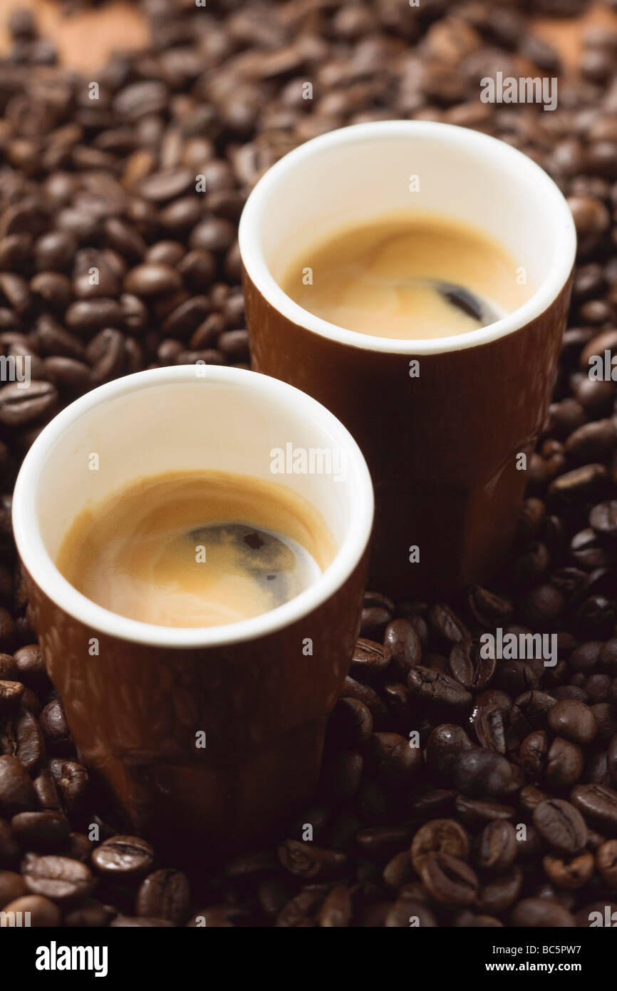 Due espresso in piedi sul caffè in grani - Foto Stock