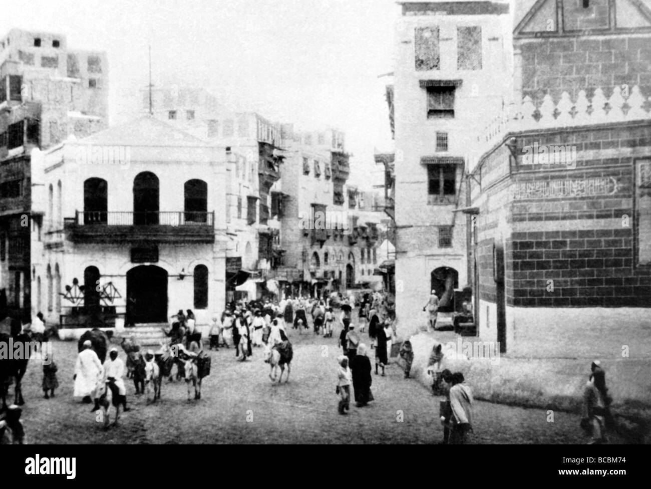 Arabia Saudita popolo storico nella strada principale della Mecca con la Grande Moschea sulla destra e a una stazione di polizia sulla sinistra Foto Stock