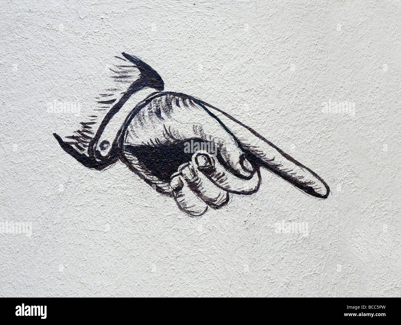 Dipinto sul muro della mano di puntamento Foto Stock