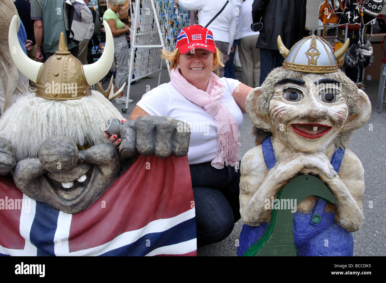 Donna turistica in posa con i troll al di fuori del negozio di souvenir, Olden, Nordfjordeid, Sogn og Fjordane, Norvegia Foto Stock