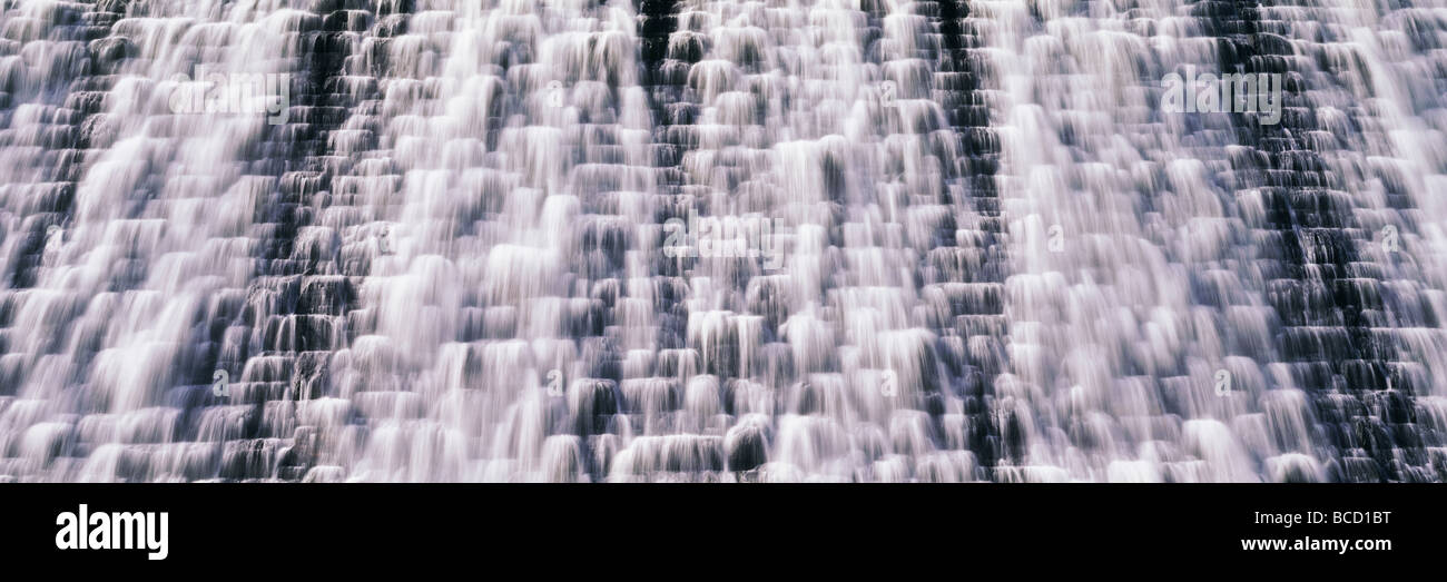 Acqua tumbling oltre il recinto di dam. Lago Vymwy. Il Galles. Foto Stock