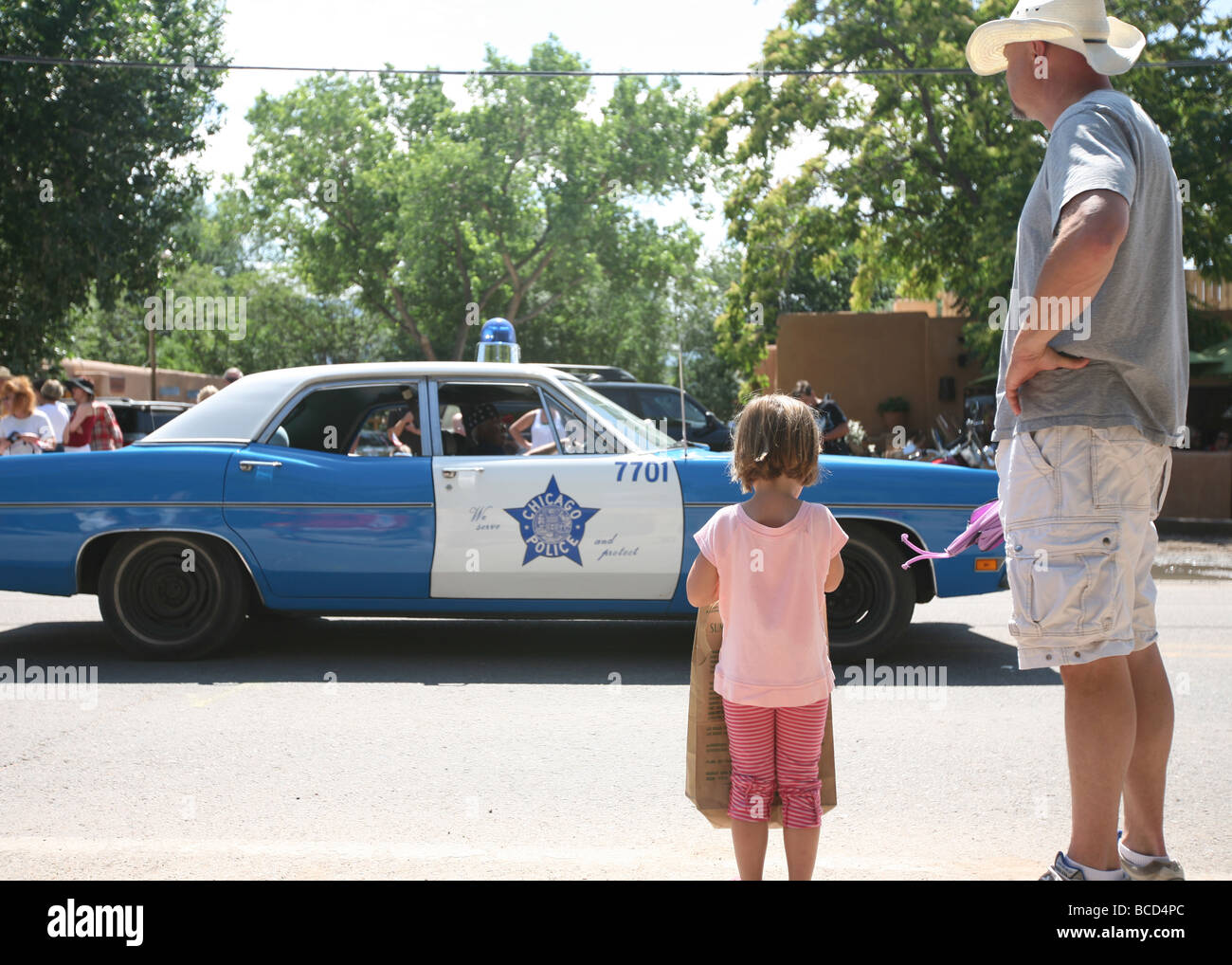 Padre e figlia guardando auto della polizia in 4 di luglio parade Foto Stock