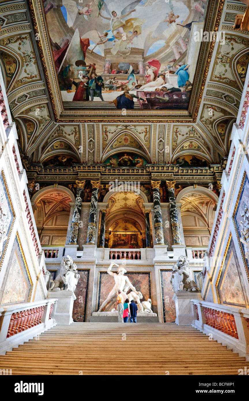Kunsthistorisches Museum Grand Staircase with Sculpture Vienna Austria // VIENNA, Austria — la grande scalinata del Kunsthistorisches Museum presenta una grande scultura alla sua base, con soffitti e pareti ornate da affreschi e decorazioni intricate. Inaugurato nel 1891, il museo è rinomato per la sua vasta collezione di opere d'arte e manufatti storici che spaziano dall'antico Egitto all'antichità classica e all'arte europea dal Medioevo al Rinascimento. La sua architettura sontuosa riflette la dedizione dell'Impero austro-ungarico all'arte e alla cultura. La collezione del museo include il mastice Foto Stock