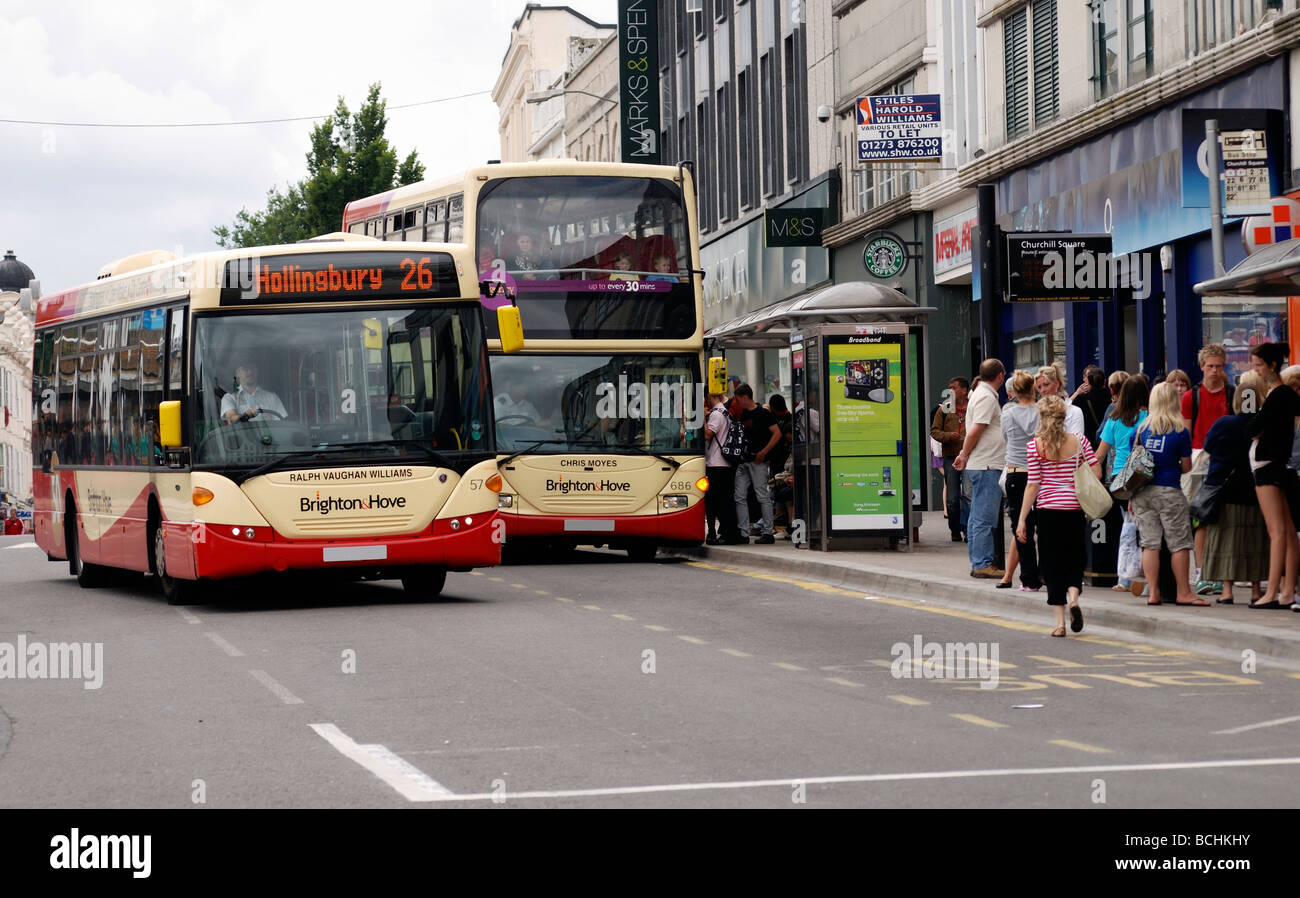 Un autobus che passa un altro come si preleva i passeggeri da una fermata d autobus Foto Stock