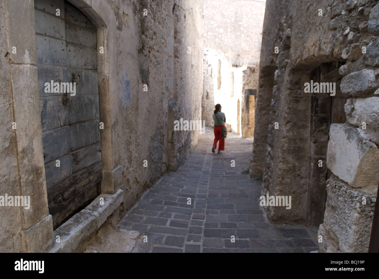 Un turista a piedi in una strada Castelvecchio Calvisio Italia Foto Stock
