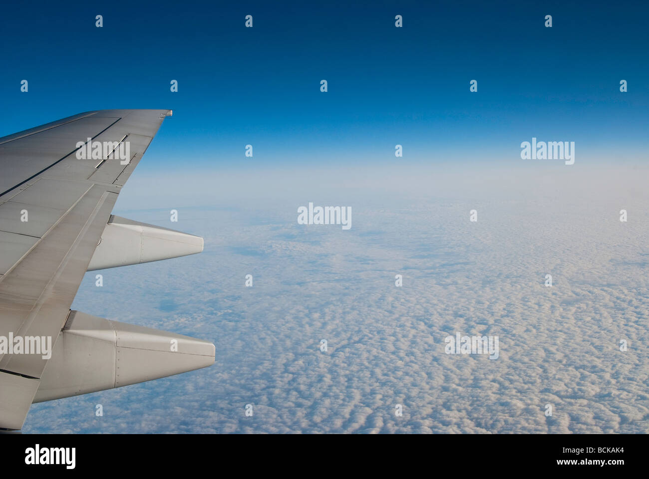 Paesaggio meraviglioso di soffici nuvole contro il cielo blu con un'ala di aereo nell'angolo Foto Stock