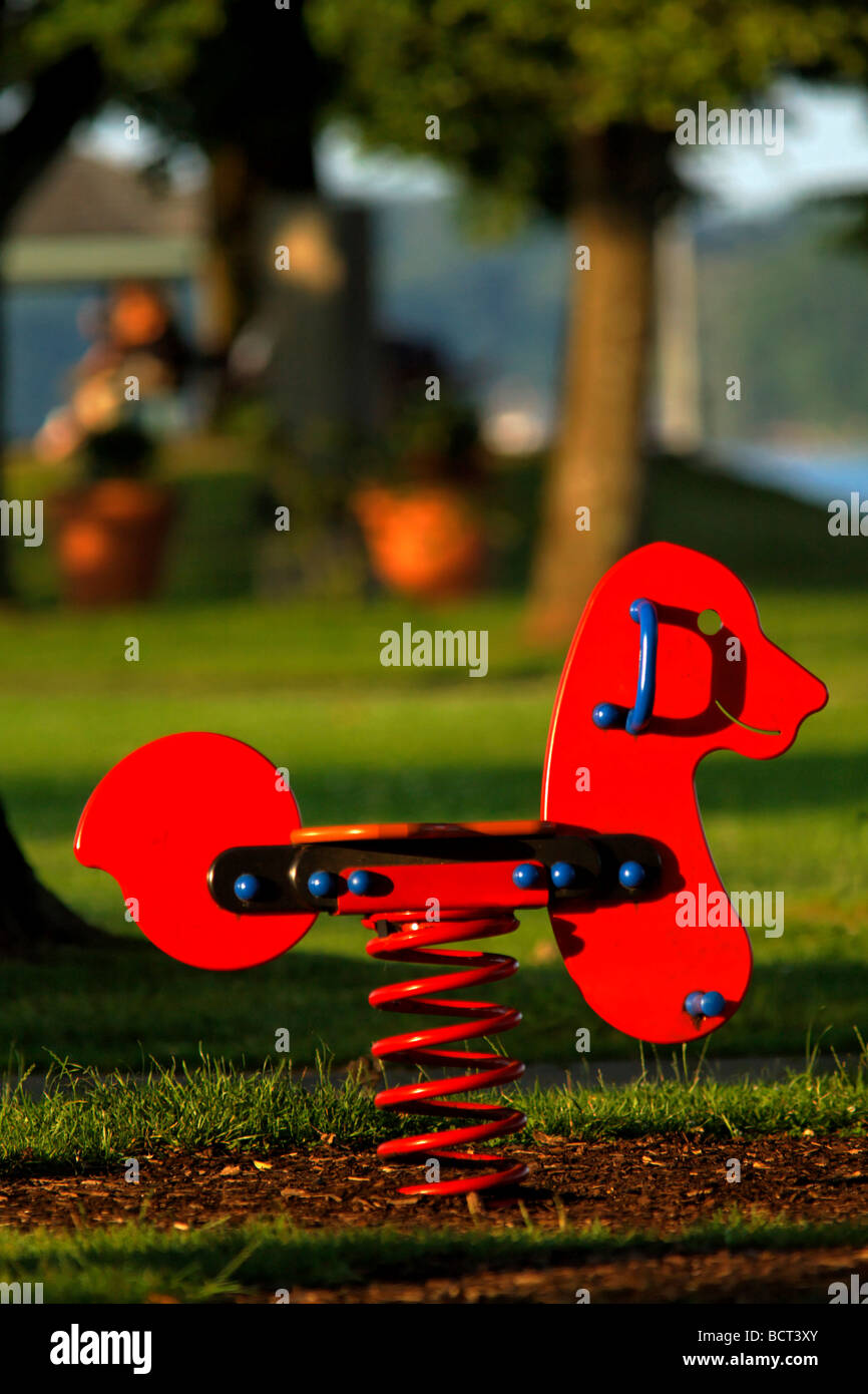 Childs a molla rosso corsa giocare nel parco giochi per bambini Foto Stock