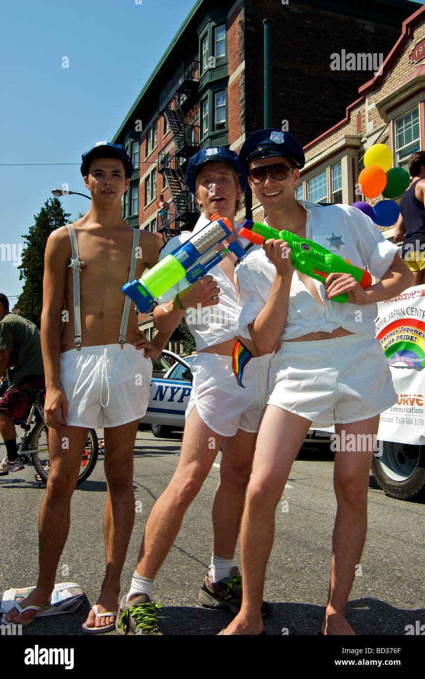Piuttosto giovani uomini in polizia cappelli pantaloncini bianchi con  squirt pistole a Gay Pride Parade Foto stock - Alamy