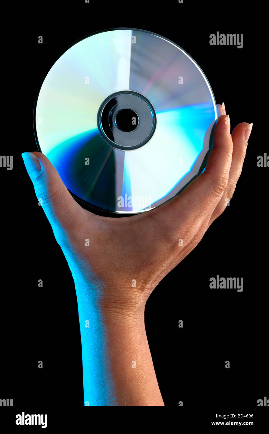 Una donna s mano che tiene un compact disc Foto Stock
