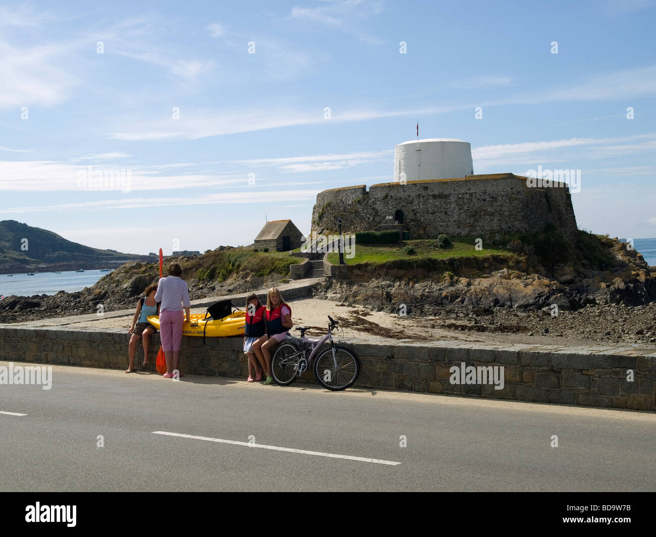 I villeggianti godendo il sole estivo al di fuori di Fort Grey Shipwreck Museum St Saviours Guernsey Foto Stock