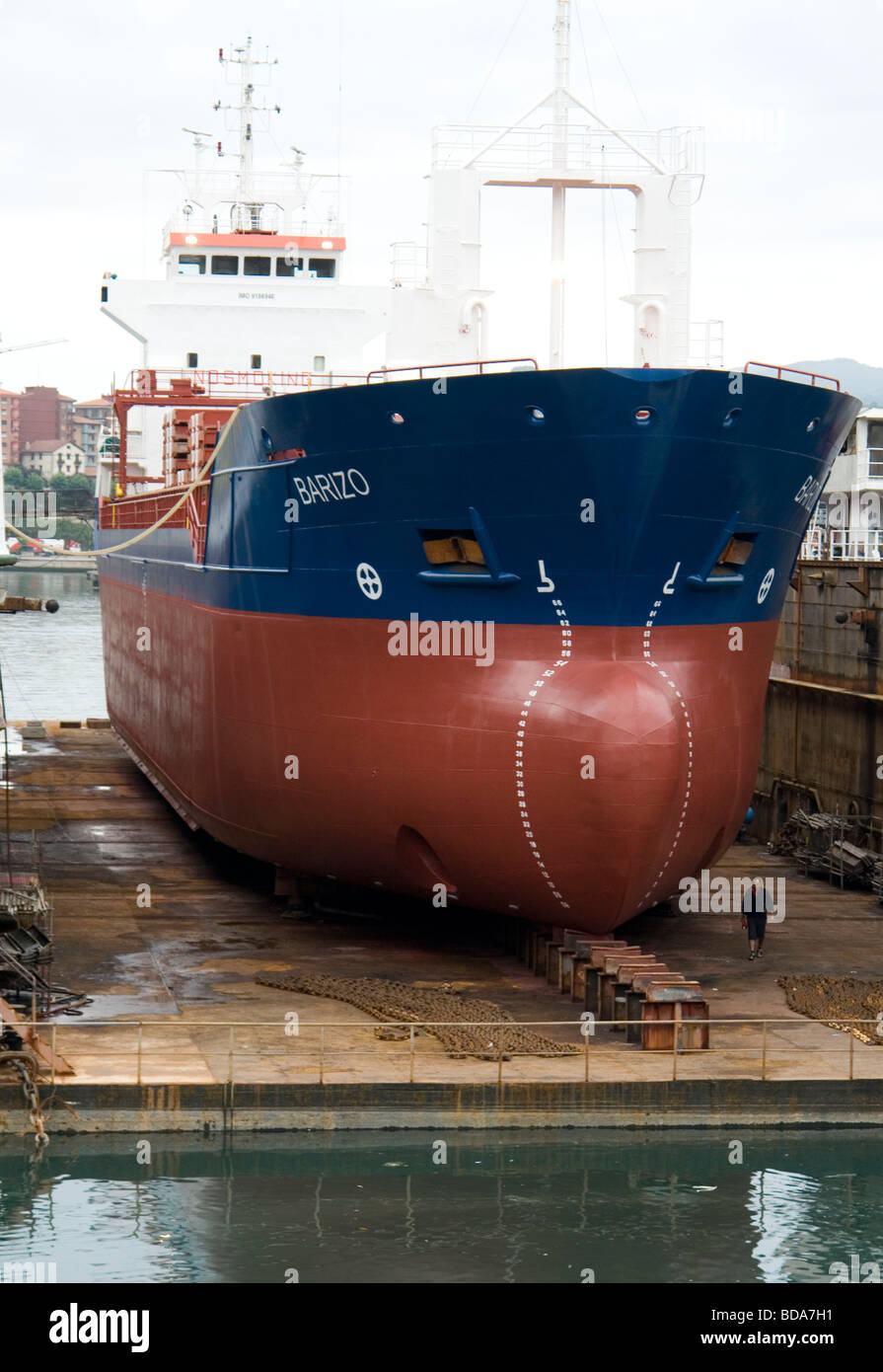 Barca da pesca nel bacino di carenaggio dopo i lavori di manutenzione nel porto di Pasajes (Spagna). Bateau de pêche en cala sèche (Espagne). Foto Stock