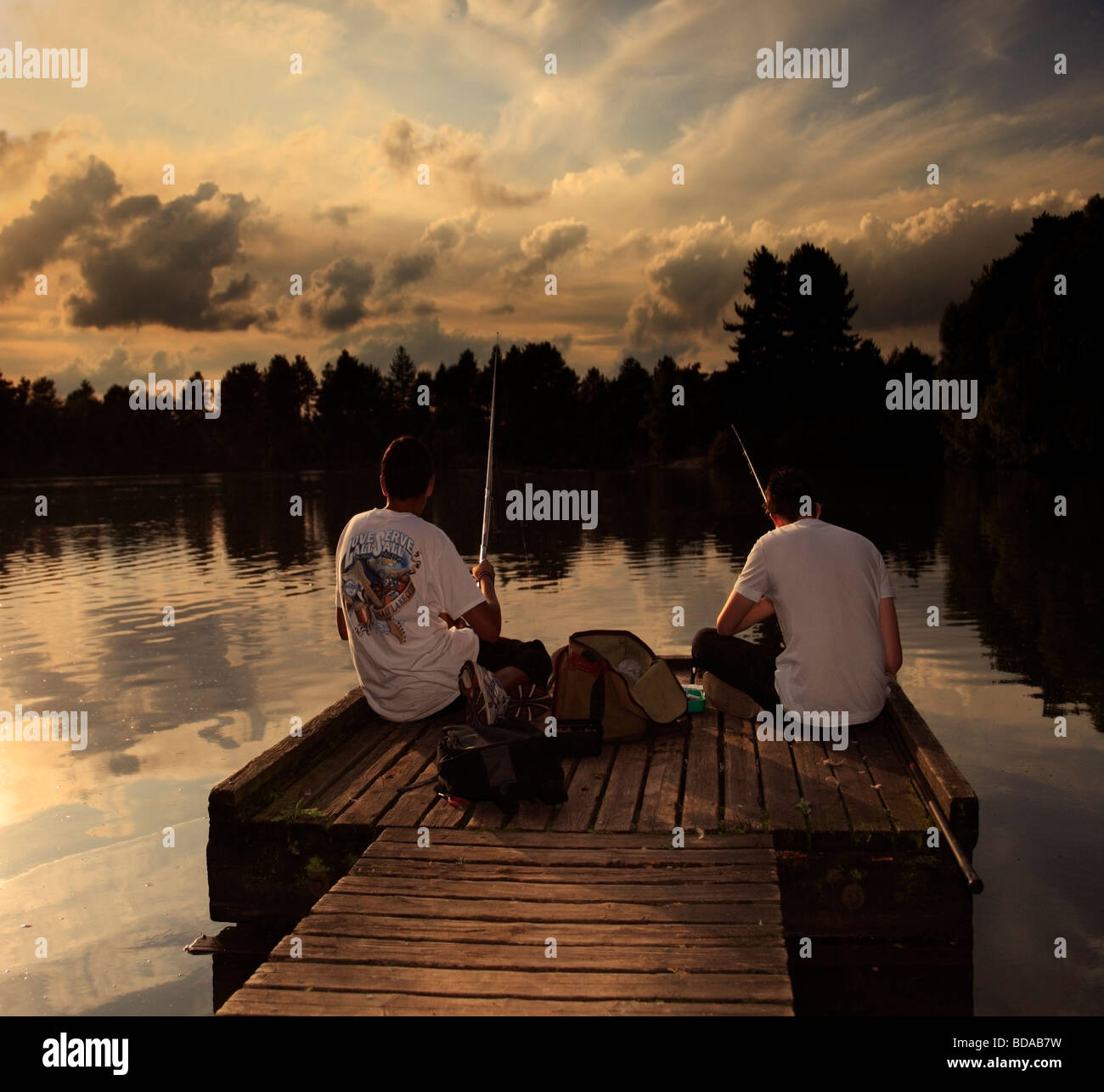 Due ragazzi la pesca al tramonto. Foto Stock