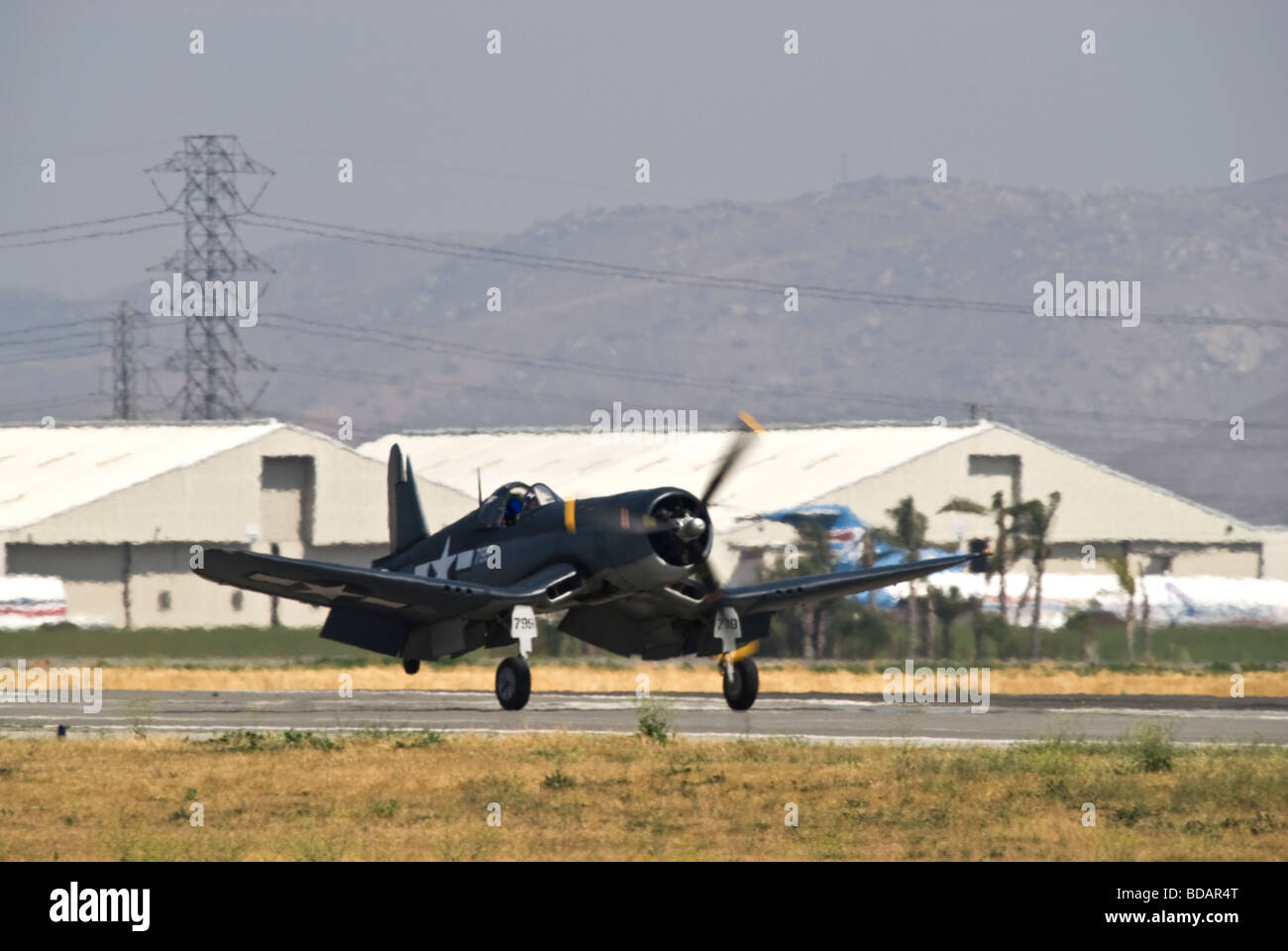 Un Chance-Vought F-4U come tocchi verso il basso sulla pista dopo il volo a un air show. Foto Stock