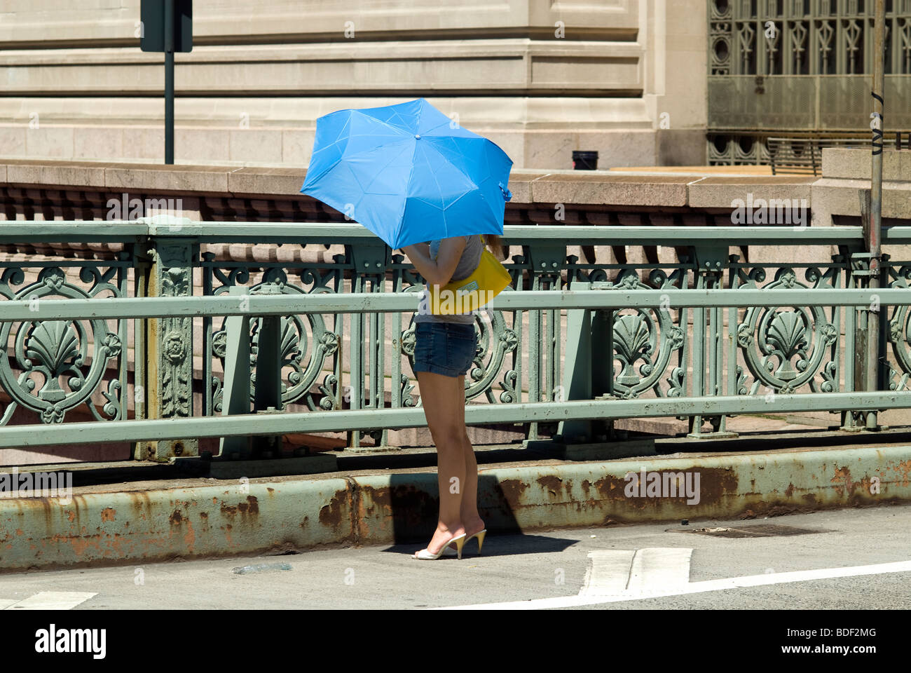 Donna usa parasol come protezione dal sole Foto Stock