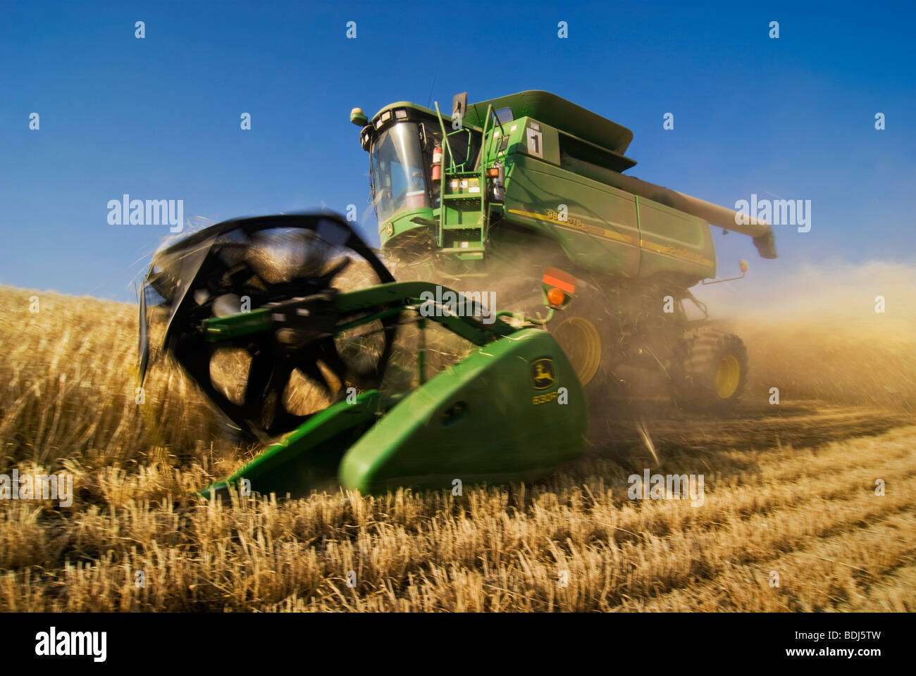 Agricoltura - una mietitrebbia John Deere di raccolti di orzo sul pendio scosceso terreno / Regione Palouse, vicino Pullman, Washington, Stati Uniti d'America. Foto Stock