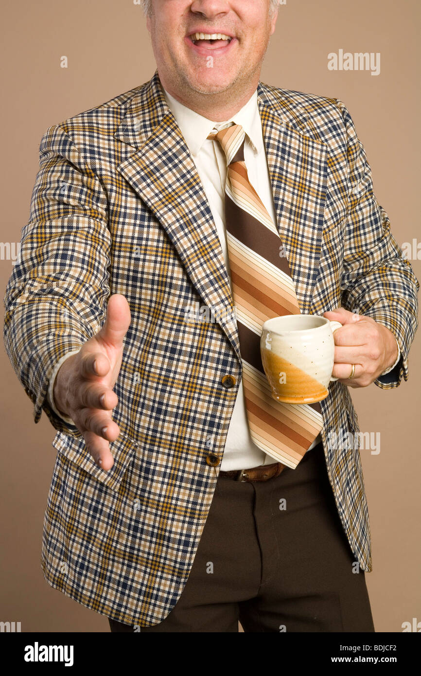Imprenditore retrò con una tazza di caffè per raggiungere una stretta di mano Foto Stock